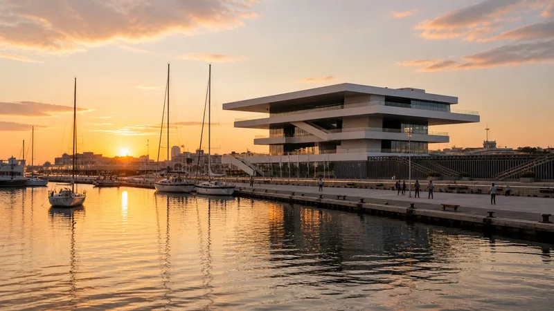 Veles e Vents reflejado en la dársena de la Marina de València al atardecer